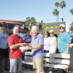 Mike McMillan presents the Canadian Club’s check to Marty Eckstein for the purchase of three new scoreboards for the SunBird Shuffleboard Club.