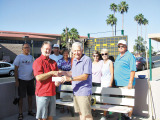 Mike McMillan presents the Canadian Club’s check to Marty Eckstein for the purchase of three new scoreboards for the SunBird Shuffleboard Club.