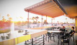 Enjoying the sunset on the new patio area are Arline and Ellie. This year Garden Club used funds from a private donation to buy new pottery for the patio areas.