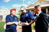 East Valley Marine Pat Rice presents Sgt. Robert Bruce with a certificate for donation from the detachment while Marine Master Sergeant Salvador Marquez of the Wounded Warrior Regiment looks on.