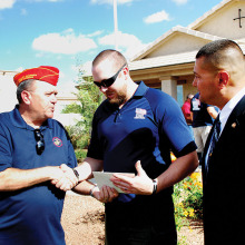 East Valley Marine Pat Rice presents Sgt. Robert Bruce with a certificate for donation from the detachment while Marine Master Sergeant Salvador Marquez of the Wounded Warrior Regiment looks on.