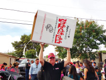 John Van Houten, Maricopa County Toys for Tots chairperson for the past five years, carries an emptied toy box back to the delivery truck.
