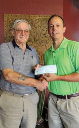 Fred Garmeson presenting a check To Layne Varney