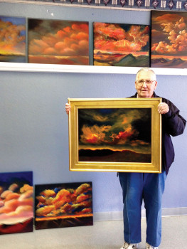 Virgil Baker proudly displays his painting from our ‘Clouds’ class taught by Art Norby.