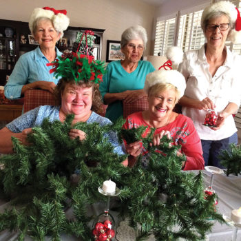 DW members Gwen Fleming, Kay King, Susan Anderson and seated Diane Gramze and LaVerne Walters are working on table decorations for the December 3 P.E.O. Luncheon at Palo Verde Country Club dining room.