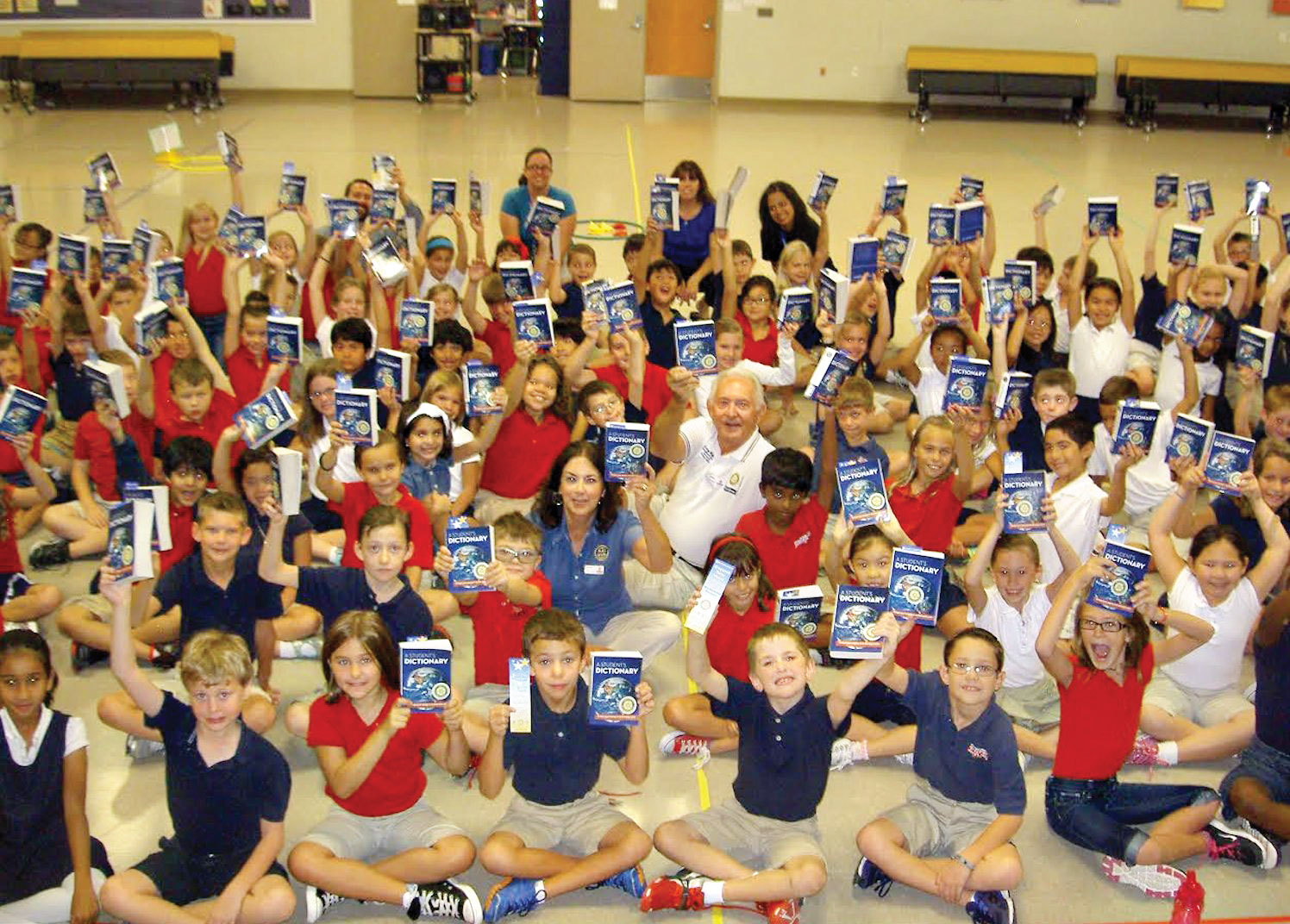 Rotarians Gary and Bonnie Whiting present dictionaries to third grade students at Navarette Elementary School.