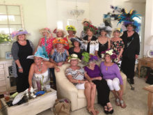 Ladies decorated straw hats for prizes at Kentucky Derby innovative party.