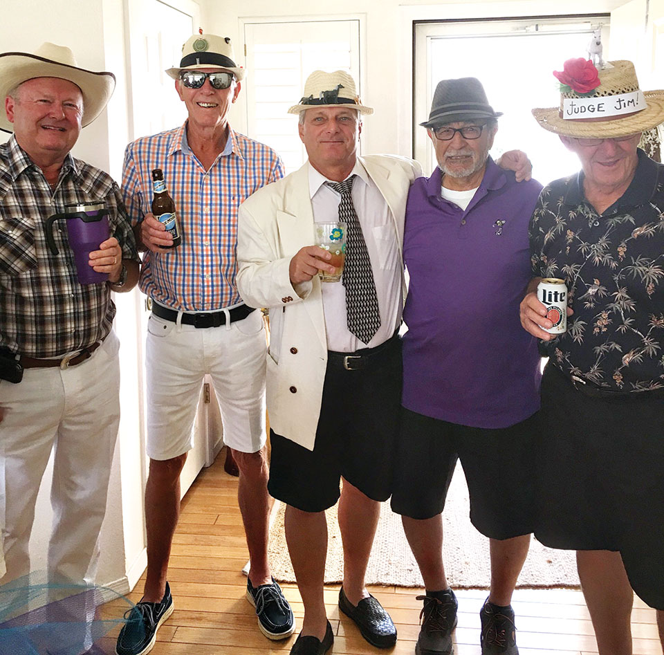 Men showing off their hats and attire at Kentucky Derby innovative party