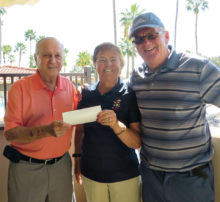 Jerry Lingen receives a check from Bev Launer, Bandit president, and Richard Craig, the Bandit tournament chairman.