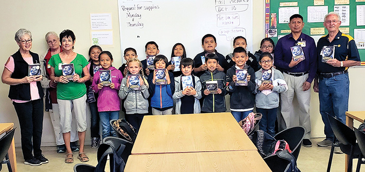 St. Bonaventure 3rd grade students holding their new dictionaries.
