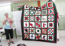Diana Jones is showing the beautiful quilt that her mother Bobbie Woodward made from a basket of quilt blocks she received from her quilt group at a holiday party in the White Mountains, Show Low area.