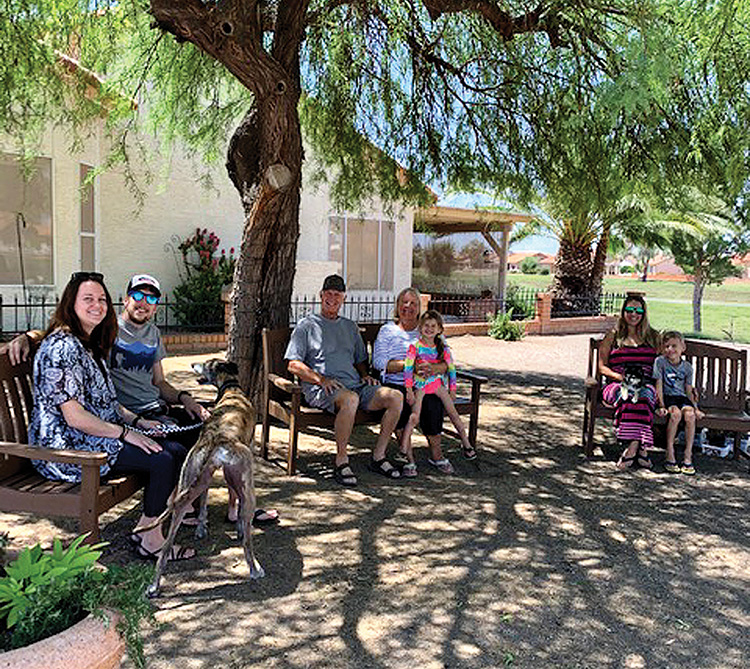 Enjoying the park-like setting are (from left) Alyse and Ryan Birkemeyer with their dogs Archer and Roux, new SunBird homeowners Glenn and Karen Birkemeyer holding granddaughter Aubrey Reinhard, and Kristin and Myles Reinhard. A great meeting place for coffee, to visit, or just enjoy the view!